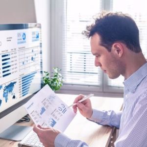 A man observes a data sheet while working in a remote environment.